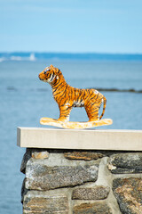 Stuffed Tiger on a ledge with the water in the background 