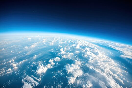 A breathtaking view of Earth"s curvature with clouds and the blue atmosphere seen from high altitude.