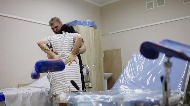 Husband supports pregnant wife with prenatal labor in delivery room. The concept of joint labor, birth and support.
