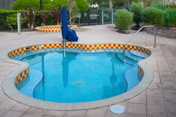 A quiet hot tub waits in stillness, its waters calm and untouched.