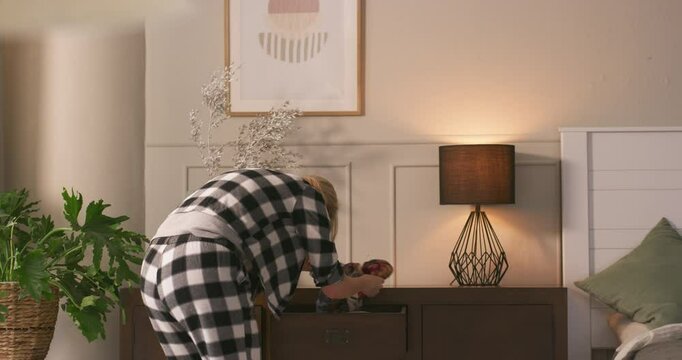 Woman, looking and throw clothes in home with desperate search, lost item and mental health anger. Back, frustrated and person with depression in bedroom for outfit rummage, dresser chaos and annoyed