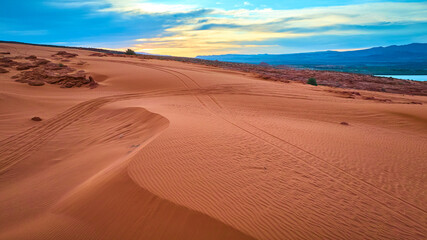Aerial Sand Dunes and Red Rocks with Tire Tracks at Sand Hollow State Park Utah