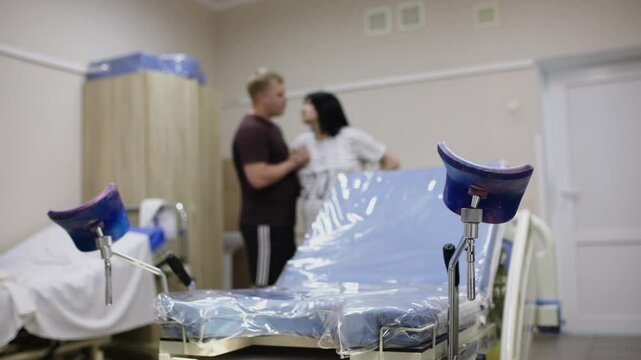 A husband hugs his wife during labor in the delivery room. The concept of childbirth and support.
