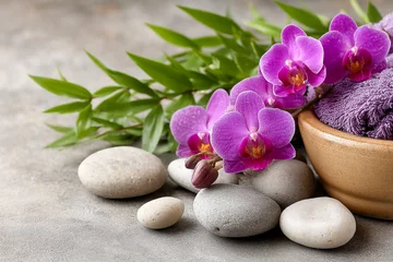 Serene spa setting with purple orchids and smooth stones