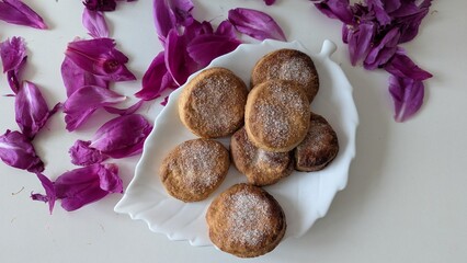 A delectable pile of homemade sugar cookies, lightly dusted with sugar, presented in a charming...