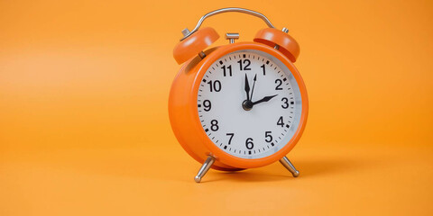 Vintage orange alarm clock on orange background with copy space. Retro time, antique clock with details. Classic design, decoration, reminder, display. Analog clock. 
