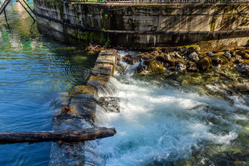 A river rapid of water flowing out of the crystal clear mountain lake Ritsa. The river Yupshara flows out of Lake Ritsa. 