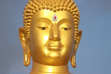  The close up Gold Buddha face statue