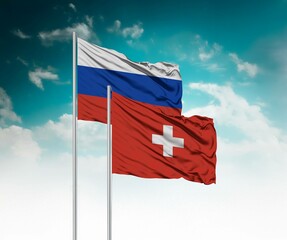  National flags of Russia and Switzerland wave side by side in a clear blue sky symbolizing international unity and cooperation.