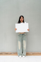 young woman holding a white board
