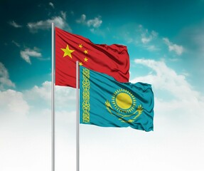  National flags of China and Kazakhstan wave side by side in a clear blue sky symbolizing...