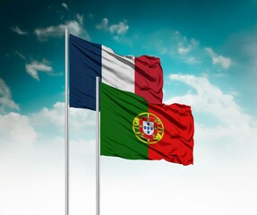  National flags of France and Portugal wave side by side in a clear blue sky symbolizing...
