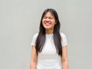 portrait of a young woman laughing with eyes closed
