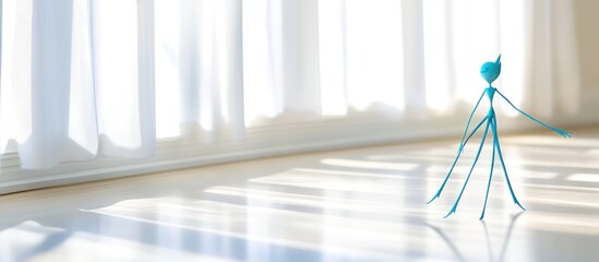 Teal figurine near window, sunlit floor, calm background, website design