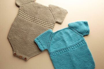knitted baby romper and accessories on neutral fabric background flatlay newborn outfit