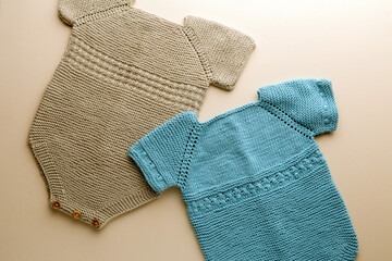 knitted baby romper and accessories on neutral fabric background flatlay newborn outfit