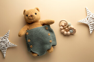 knitted baby romper and accessories on neutral fabric background flatlay newborn outfit