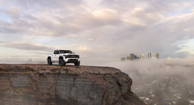 Toyota Tacoma TRD Pro 2024 on Scenic Cliff with City Skyline View