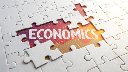 Economics concept represented by a partially assembled jigsaw puzzle illustrating the idea