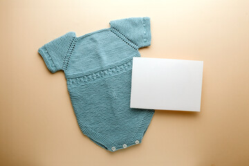 Newborn baby clothes mockup featuring hand-knitted, soft, and cozy babywear flatlay with a minimalist infant outfit