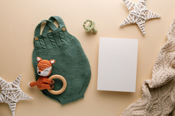 Newborn baby clothes mockup featuring hand-knitted, soft, and cozy babywear flatlay with a minimalist infant outfit