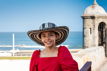 Beautiful young girl tourist wearing a sombrero vueltiao in Cartagena. Colombian people. Travel concept.