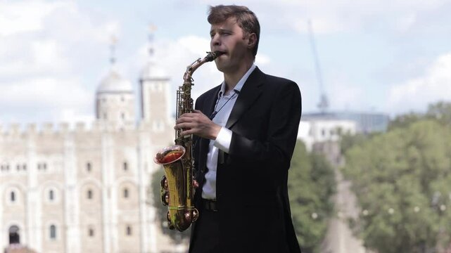 Musician in a blazer and white shirt plays jazz during the d