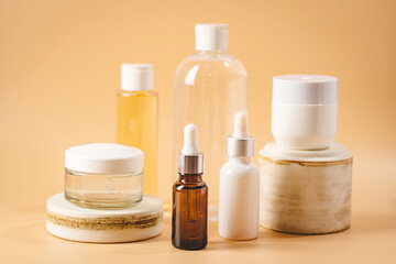 Set of natural cosmetics for face care serum, cream and micellar water on pastel blurred background