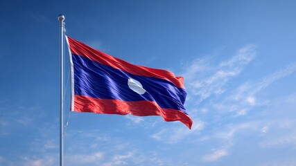 Flag of Laos displayed proudly against a clear blue sky on Independence Day celebration