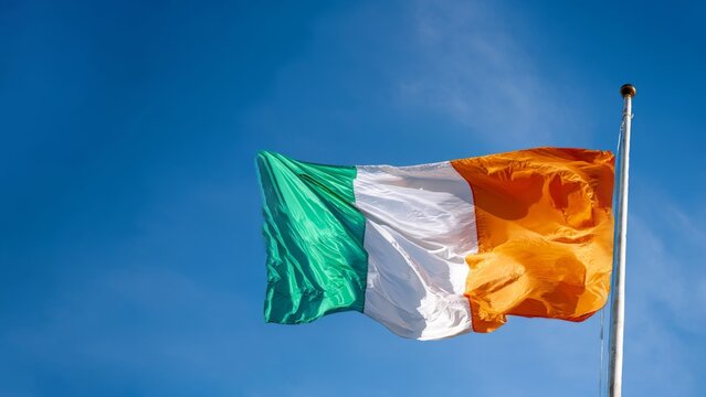Celebrating Cote d'Ivoire Independence Day with vibrant national flag waving against clear blue sky