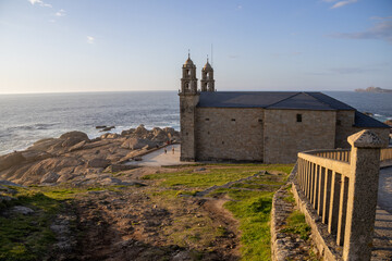 Sanctuary of A Virxe da Barca in Muxía, Galicia, Spain, perched on dramatic Atlantic cliffs. A key...