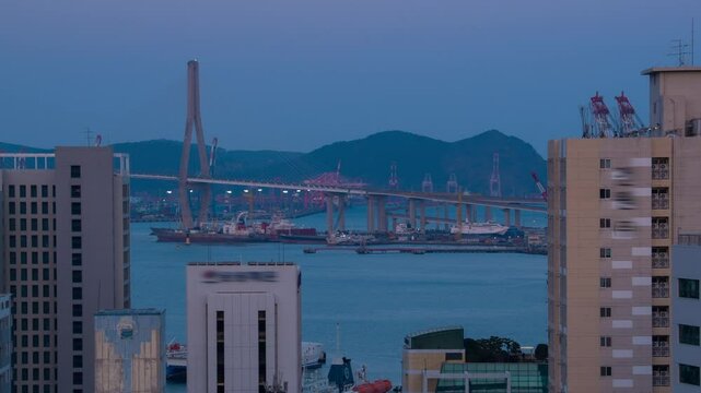 Busan, South Korea. Aerial view of skyscrapers in Busan, South Korea. Time-lapse during a cloudy spring evening, zoom in