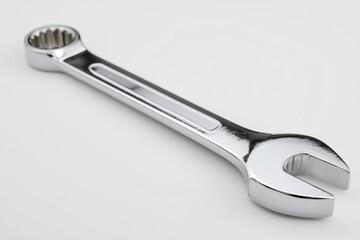 Obraz premium A shiny chrome wrench isolated on a white background, ideal for tool and mechanic related projects.