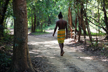 Vedda tribesman of Sri Lanka stands in natural surroundings, representing indigenous culture, traditional lifestyle, and connection to nature. Tribal portrait in native Habitat. 02.03.2022 SRI LANKA