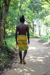 Vedda tribesman of Sri Lanka stands in natural surroundings, representing indigenous culture, traditional lifestyle, and connection to nature. Tribal portrait in native Habitat. 02.03.2022 SRI LANKA