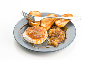 Goat cheese roll with caramelized onion on plate