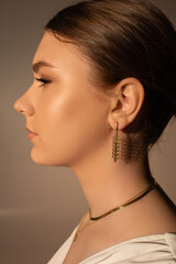 girl's face in profile with an earring in her ear