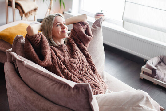 Happy middle aged Woman relaxing at home