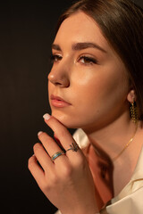 Obraz premium girl's face in profile with hand near face