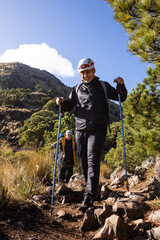 Adventurers conquer challenging rocky terrain on a sunlit hike