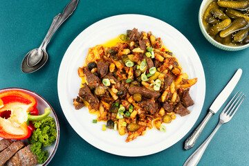 Meat stew made from beef with potatoes and pickles.