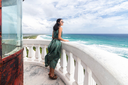 Woman in green dress looking over the Caribbean Sea from Cozumel
