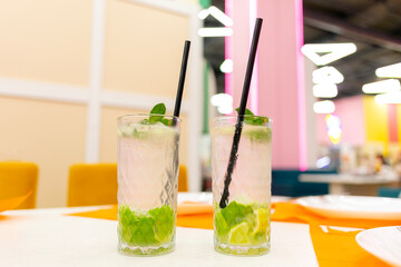 Mojito cocktails on a table in a restaurant.