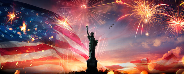 Independence Day Celebration - 4th July - Usa Flag With Fireworks And Statue of Liberty In Abstract Skyline © Romolo Tavani