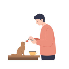 Man feeding cat with a spoon while sitting at a table indoors  