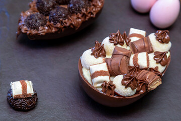 Chocolate easter eggs on top of black stone with wooden background