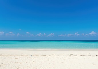 Obraz premium Bright turquoise tropical sea and white sandy beach under a clear blue sky. Empty caribbean ocean and vacation paradise backdrop.