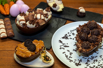 Chocolate easter eggs on top of black stone with wooden background