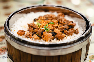 A Chinese food restaurant that serves food in bamboo steam containers. This is steam rice with pork.