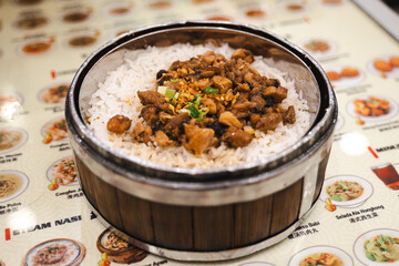 A Chinese food restaurant that serves food in bamboo steam containers. This is steam rice with pork.